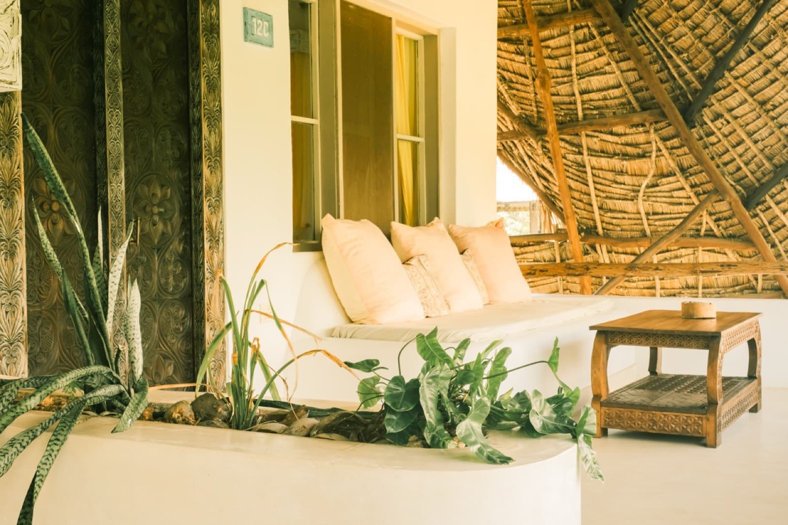 A shaded veranda under a makuti roof